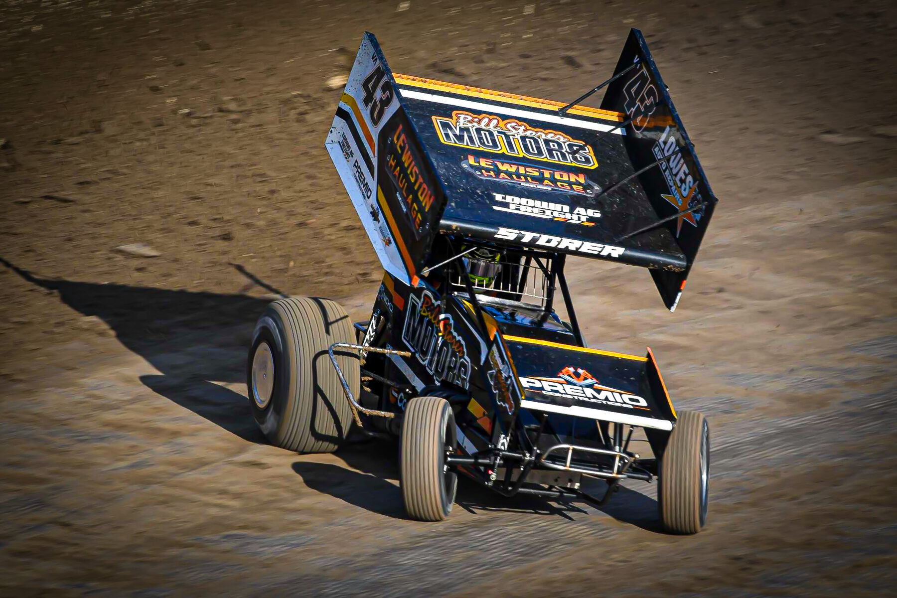 The #43 Sprintcar throwing dirt through a corner